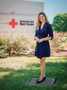 Beth Sweney standing in front of an American Red Cross building