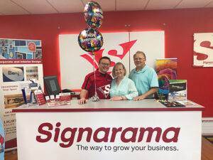 Valiant family behind the counter at Signarama