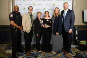 New Explore Evansville President and CEO Tom White (far right) was on hand March 18 when Evansville Police Chief Philip Smith (far left) presented Explore Evansville’s Collin Dame, Kathy Glaser, Kate Reibel, and Angela Ellison with Leadership Everyone’s 2025 public service project recognition award for its tourism promotion around the April 8, 2024, total solar eclipse. White joined the city’s tourism and convention agency March 3. Photo provided by Leadership Evansville