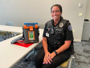 Photo by Jodi Keen. Newburgh Police Department Officer Mallory Ladd received an AED from HeartSaver on Aug. 14 for St. John the Baptist Catholic School.