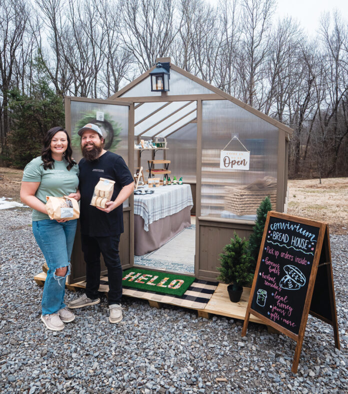 Abby and Tim Smith pose by their freestanding homestead.
