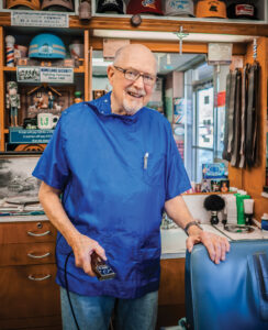 Ronald Korff stands in his barbershop.