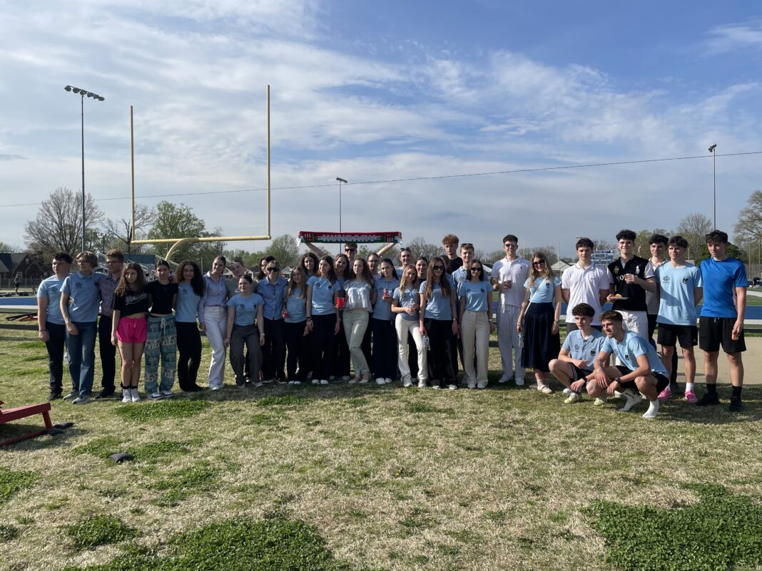High school students pose in a line for a group photo