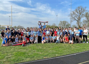 High school students pose in a line for a group photo