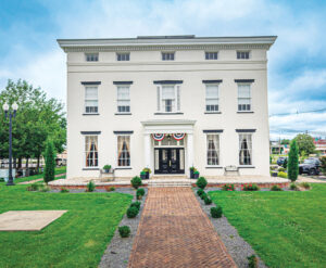 Photo of a two-story historic home built in the Greek Revival style