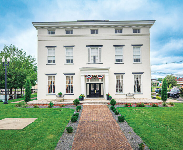 Photo of a two-story historic home built in the Greek Revival style