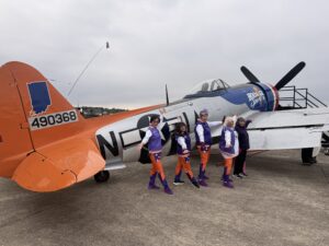 Photo of Silver Ace dancers Insook Beach, Elissa Inez Bakke, Mary Barron, Susie Woods, and Susan Feller at the 5K on the Runway. Insook and Elissa are going to Washington, D.C., along with Erin Lewis (not pictured) and Amy Mangold (not pictured)