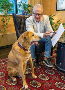 Photo of Publisher Todd Tucker wearing a Johnny Carson-like sportcoat, and Jed looking fashionable in his University of Louisville collar by Lindsey McIntosh