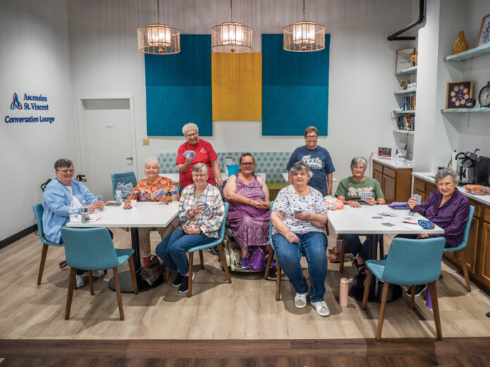 Diane Alldredge, Dinah Levi, Pat Durchholz, and Donna Klausmeier play a game of clabber in SWIRCA's Ascension St. Vincent Conversation Lounge on July 13, 2026. At the next table, Brenda Beecher, Mary Pearl, Linda Moore, Dolores Higgs, and Sue Deifrig play gin rummy. Photo by Zach Straw