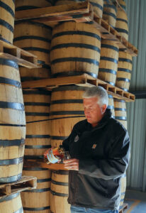 Photo of master distiller Jacob Call with a bottle of Silk Velvet provided by Silk Velvet