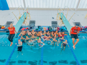 swim team in pool above overhead photo deep end between diving boards